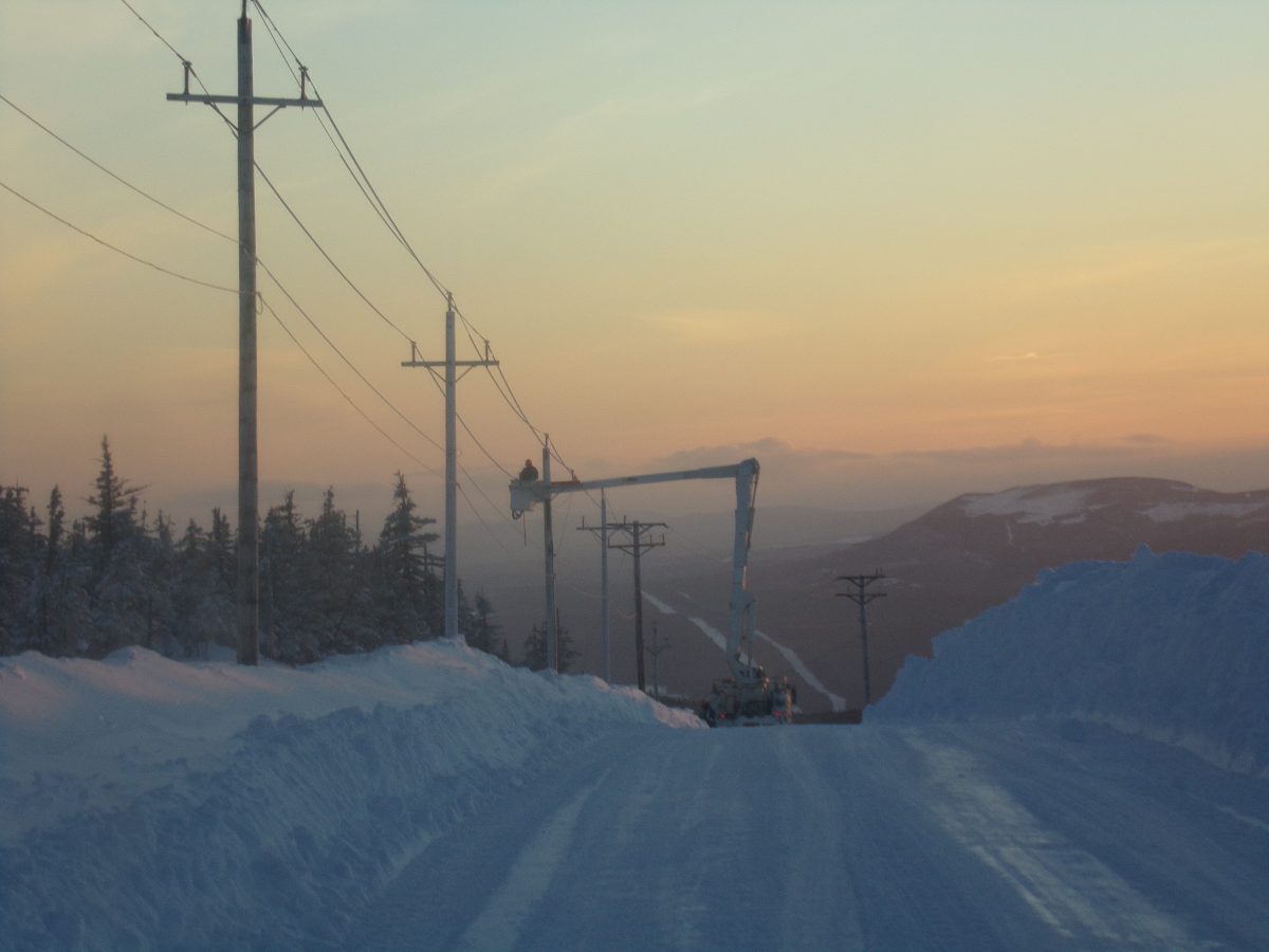 Our team at Holland Power Services responding to power line in the winter at sunset.